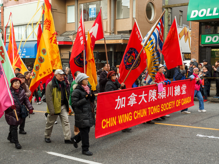 VANCOUVER, CANADA - February 2, 2014: Chin Wing Chun Tong society of Canada marching at Chinese New Year parade in Vancouver Chinatown.のeditorial素材