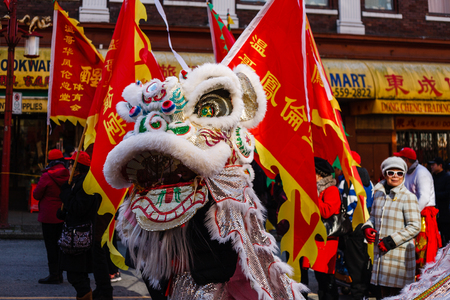 VANCOUVER, CANADA - February 18, 2014: People in White Lion Costume at Chinese New Year parade in Vancouver Chinatown.のeditorial素材