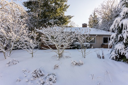 VANCOUVER, CANADA - February 24, 2018: Winter morning after a night of snow blizzard old house at...