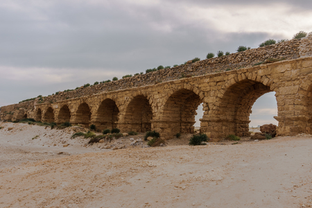 Ancient Roman ruins of aqueduct in Ceasarea Israel historical monumentの写真素材