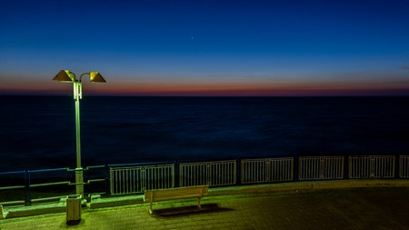 city seawall with street light after sunset at Mediterranean Seaの写真素材