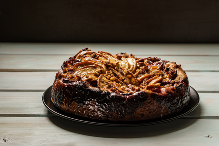 pear cake homemade pastries on a black plate on tableの写真素材