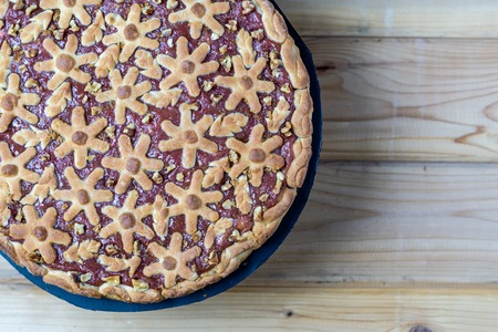 cake with berries and rhubarb on a wooden table