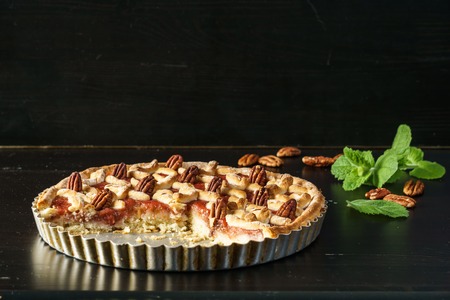 cake with berries and rhubarb on a black tableの写真素材
