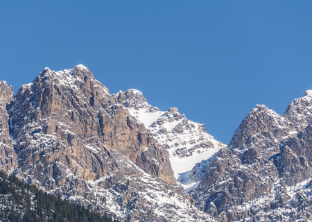 view of rocky mountains on a sunny spring day with clear blue sky