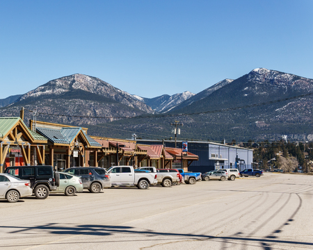 INVERMERE, CANADA - MARCH 21, 2019: main street in small town in British Columbia with shops restaurants carsのeditorial素材