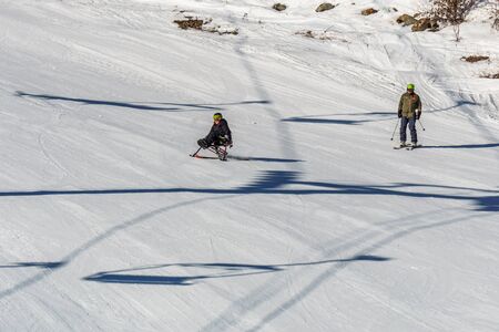 KIMBERLEY, CANADA - MARCH 22, 2019: handicapped person riding a sit-skis Vancouver Adaptive Snow Sportsのeditorial素材