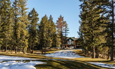 FAIRMONT HOT SPRINGS, CANADA - MARCH 22, 2019: Golf Course field in small town in rocky mountains sunny afternoonのeditorial素材