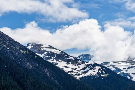 alpine landscape view from Garibaldi provincial park with peaks covered by snow and clouds