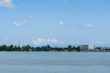 RICHMOND, CANADA - AUGUST 3, 2019: Panoramic view of Fraser river commercial shipping.