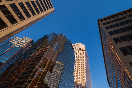 VANCOUVER, CANADA - FEBRUARY 19, 2020: look up to tall buildings with blue sky in downtown.