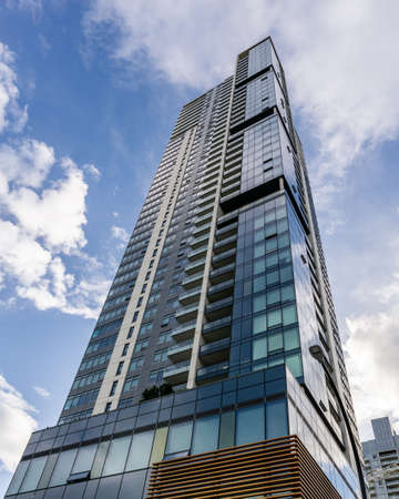 BURNABY, CANADA - JUNE 19, 2019: look up to tall buildings with blue sky in downtown.