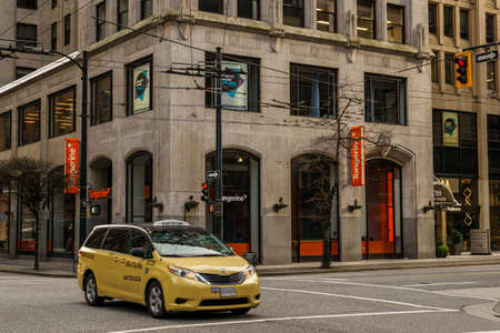 VANCOUVER, CANADA - FEBRUARY 2, 2020: yellow cab taxi car on street downtown