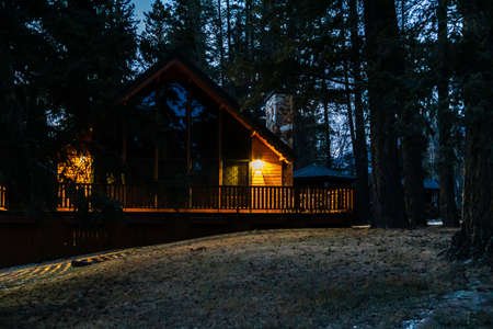 FAIRMONT HOT SPRINGS, CANADA - MARCH 19, 2020: wooden house at night in small town situated in rocky mountainsのeditorial素材