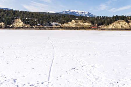 INVERMERE, CANADA - MARCH 17, 2020: frozen Windermere lake and rocky mountains in british columbia canadaのeditorial素材