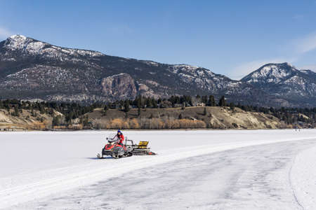 INVERMERE, CANADA - MARCH 17, 2020: life on frozen Windermere lake and rocky mountains in british columbia canadaのeditorial素材