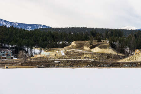 INVERMERE, CANADA - MARCH 17, 2020: frozen Windermere lake and rocky mountains in british columbia canadaのeditorial素材