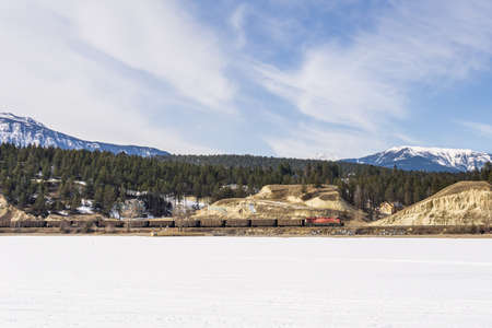 INVERMERE, CANADA - MARCH 17, 2020: frozen Windermere lake and rocky mountains in british columbia canadaのeditorial素材