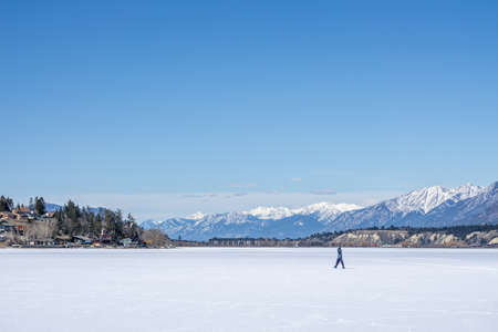 INVERMERE, CANADA - MARCH 17, 2020: frozen Windermere lake and rocky mountains in british columbia canadaのeditorial素材
