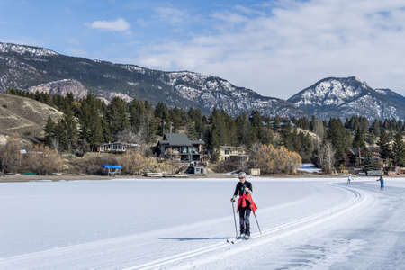 INVERMERE, CANADA - MARCH 17, 2020: frozen Windermere lake and rocky mountains in british columbia canadaのeditorial素材