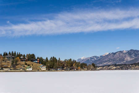 INVERMERE, CANADA - MARCH 17, 2020: frozen Windermere lake and rocky mountains in british columbia canadaのeditorial素材