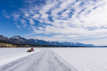 INVERMERE, CANADA - MARCH 17, 2020: life on frozen Windermere lake and rocky mountains in british columbia canadaのeditorial素材