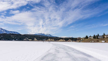 INVERMERE, CANADA - MARCH 17, 2020: frozen Windermere lake and rocky mountains in british columbia canadaのeditorial素材