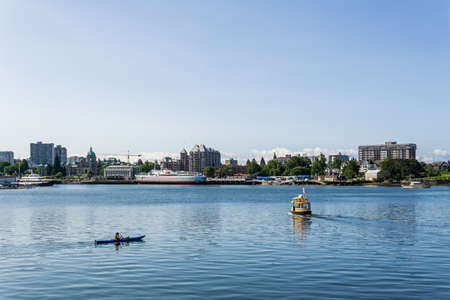 VICTORIA, CANADA - JULY 14, 2019: busy harbor at downtown area with yachts modern buildings and sea busのeditorial素材
