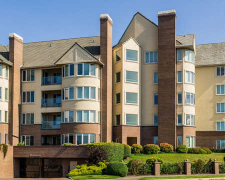 VICTORIA, CANADA - JULY 14, 2019: Modern apartment building facade view with big green lawn