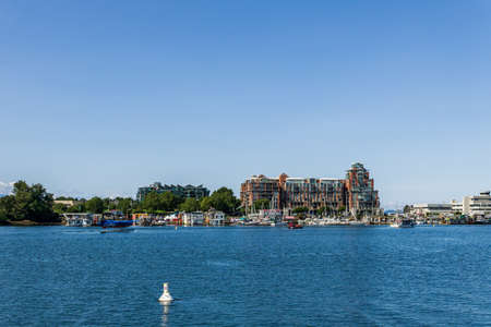 VICTORIA, CANADA - JULY 14, 2019: busy harbor at downtown area with yachts and sea plane.