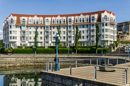 VICTORIA, CANADA - JULY 14, 2019: pathway in front of residential condo building on sunny day with blue sky.のeditorial素材
