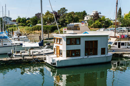 VICTORIA, CANADA - JULY 14, 2019: harbor at downtown area with yachts and modern buildingsのeditorial素材