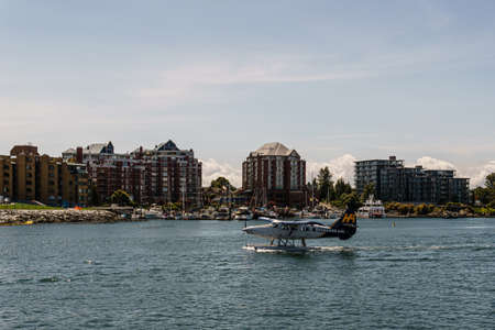 VICTORIA, CANADA - JULY 14, 2019: busy harbor at downtown area with yachts and sea plane