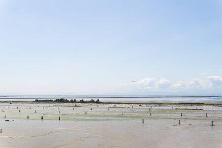 Fraser river with tugboats towing logs blue sky with clouds