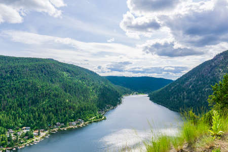 View from the top to Paul Lake Summer time with green mountains and white clouds british columbia canadaの写真素材