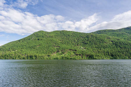 Paul Lake Summer time with green mountains and white clouds british columbia canadaの写真素材