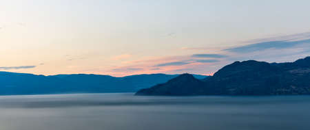 cloudy sky seen from the shore of Okanagan lake at night British Columbia Canadaの写真素材