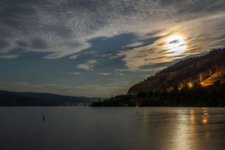 cloudy sky seen from the shore of Okanagan lake at night British Columbia Canadaの写真素材