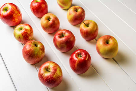 Fresh apples on a white wooden background.の写真素材