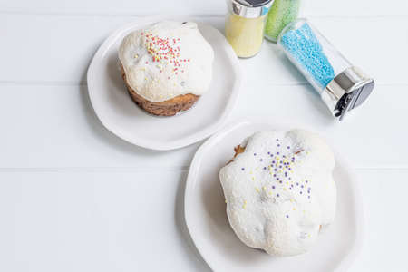 traditional ukrainian Easter cake kulich with glaze on a white wooden background Russian pastry.