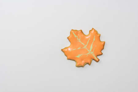 Sweet homemade leaf cookie with icing isolated on white background minimal flat lay composition.の写真素材
