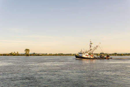 RICHMOND, CANADA - AUGUST 8, 2020: fishing boat on the Fraser River sunset time in British Columbia Canadaのeditorial素材