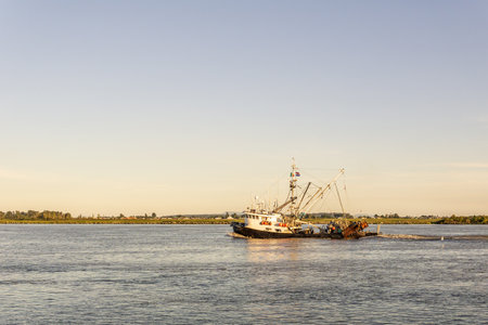 RICHMOND, CANADA - AUGUST 8, 2020: fishing boat on the Fraser River sunset time in British Columbia Canadaのeditorial素材