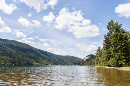 KAMLOOPS, CANADA - JULY 08, 2020: Paul Lake Summer time with green mountains and white clouds british columbia canada.のeditorial素材