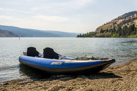 PEACHLAND, CANADA - AUGUST 01, 2020: blue inflatable kayak by the okanagan lake on a warm summer sunny dayのeditorial素材