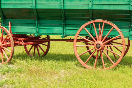 vintage cart on green grass on a summer sunny day.の写真素材