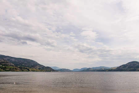 Landscape of calm lake in the morning with cloudy sky British Columbia Canadaの写真素材