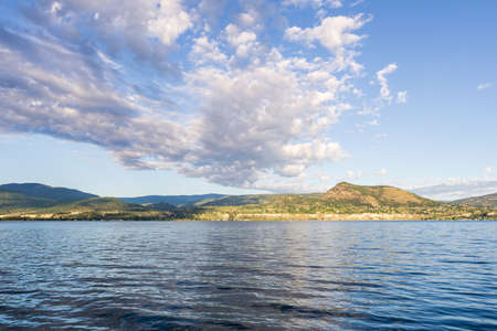 beautiful calm lake in British Columbia Canada early morning clouds on sky.の写真素材