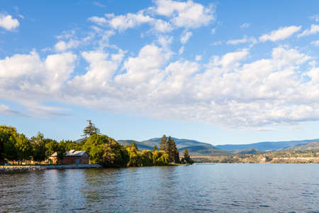 beauty sunny day on the lake wide view with white clouds on the sky.の写真素材