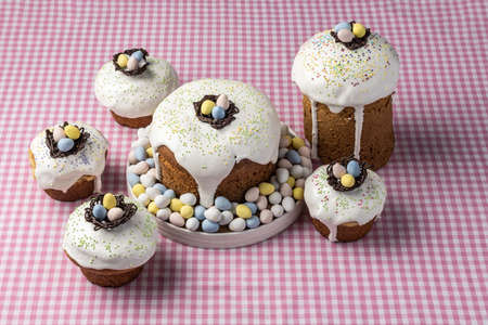several traditional Easter cakes or sweet bread and candy eggs decorated homemade pastry.